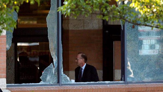 Intruder reaching through broken glass